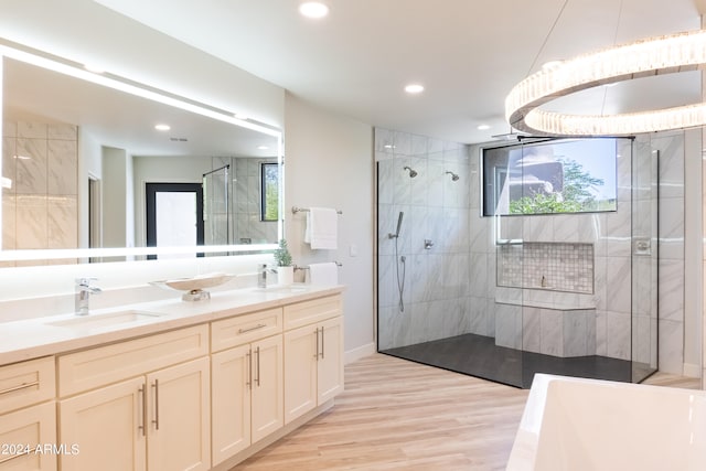 bathroom with vanity, hardwood / wood-style flooring, and a tile shower