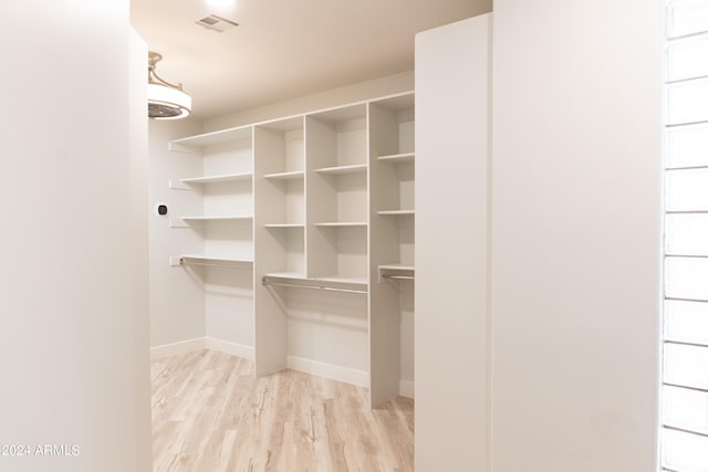 spacious closet featuring visible vents and light wood-style floors