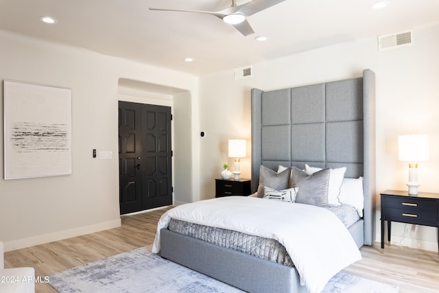 bedroom featuring light wood-type flooring, a closet, and ceiling fan