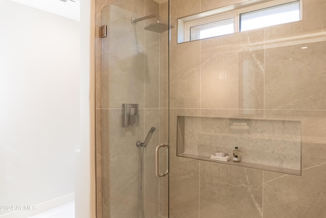 bathroom with a shower with shower door