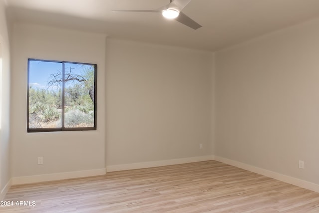 unfurnished room featuring wood finished floors, baseboards, and ceiling fan