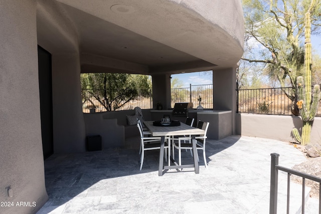 view of patio / terrace featuring grilling area, fence, and outdoor dining space