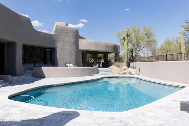 view of pool featuring a patio, a fenced in pool, and fence