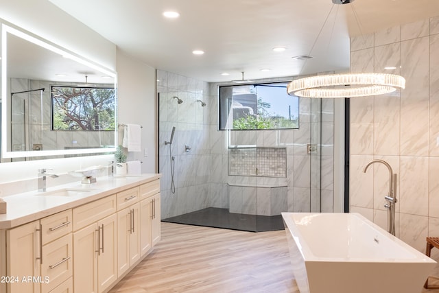 bathroom featuring vanity, independent shower and bath, tile walls, and hardwood / wood-style flooring