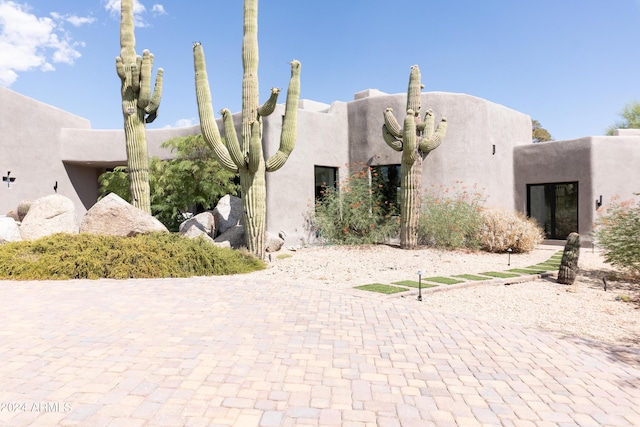 pueblo-style home with stucco siding