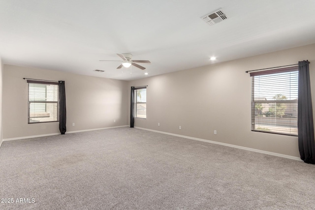 carpeted spare room with a ceiling fan, recessed lighting, visible vents, and baseboards