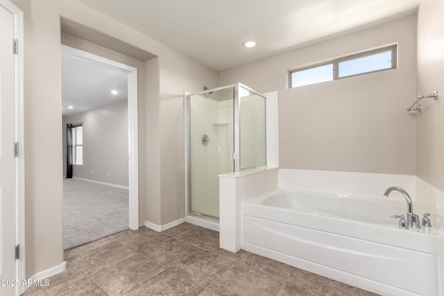 full bath with tile patterned flooring, a shower stall, baseboards, and a bath