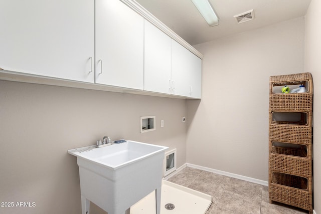 clothes washing area with washer hookup, a sink, visible vents, baseboards, and cabinet space