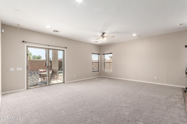 carpeted spare room featuring baseboards, visible vents, ceiling fan, and recessed lighting