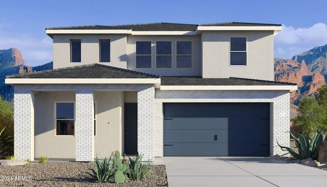 view of front facade featuring a mountain view and a garage