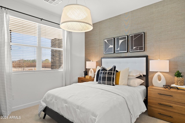 bedroom featuring light carpet