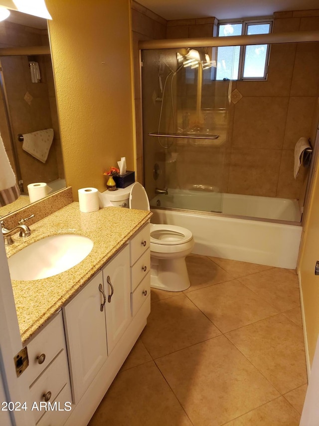 full bathroom with tile patterned flooring, combined bath / shower with glass door, vanity, and toilet