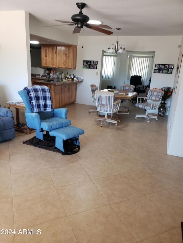 living room with ceiling fan with notable chandelier