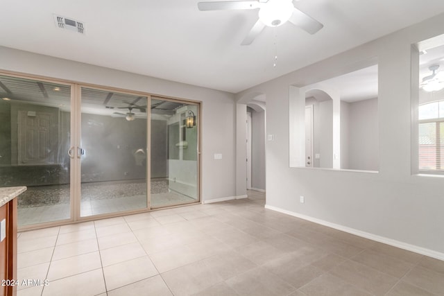 spare room featuring ceiling fan and light tile patterned floors