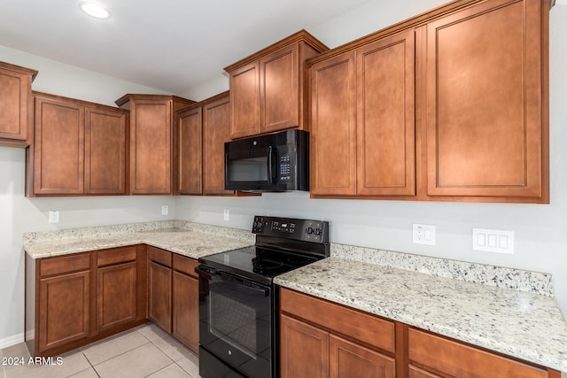 kitchen with black appliances, light tile patterned flooring, and light stone counters