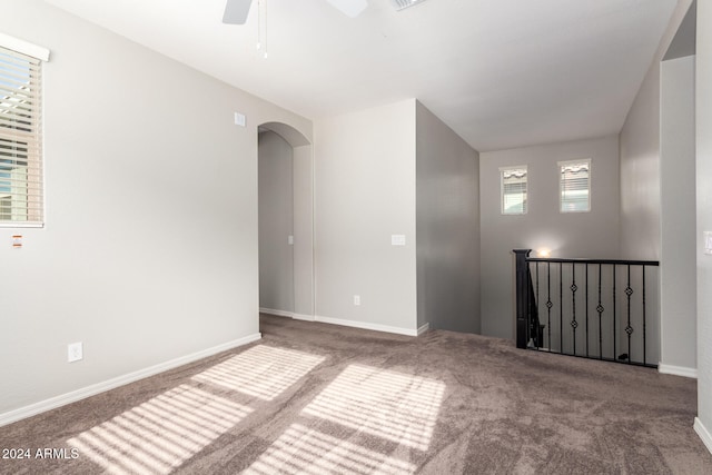 empty room featuring carpet flooring and ceiling fan