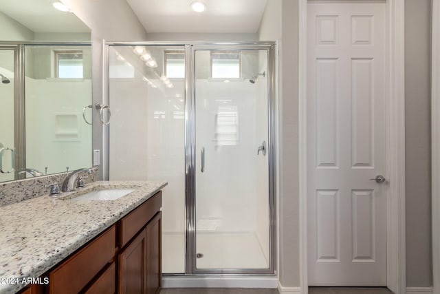 bathroom featuring vanity and an enclosed shower