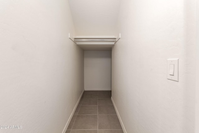 walk in closet with tile patterned floors