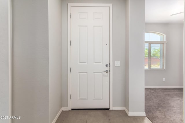 entryway featuring light carpet