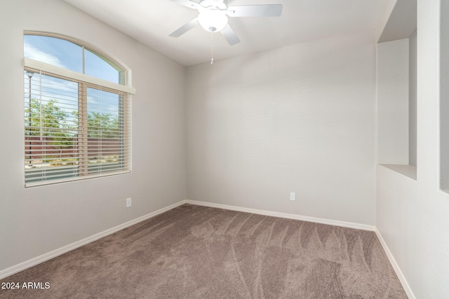 carpeted spare room featuring ceiling fan