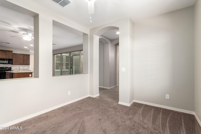 spare room featuring light colored carpet and sink