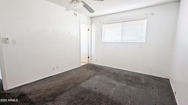 carpeted spare room with ceiling fan and a textured ceiling