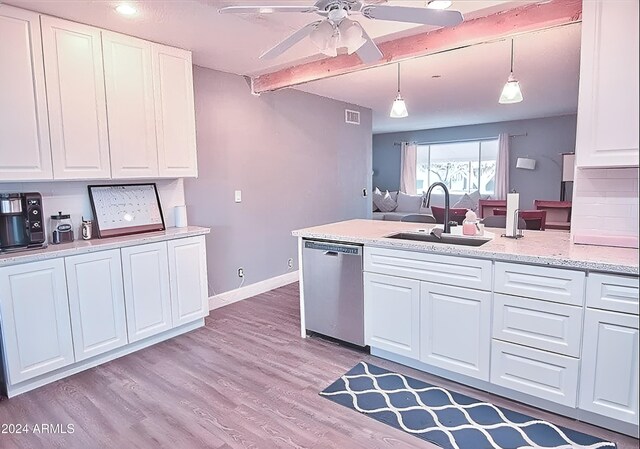 kitchen with pendant lighting, stainless steel dishwasher, white cabinetry, and sink