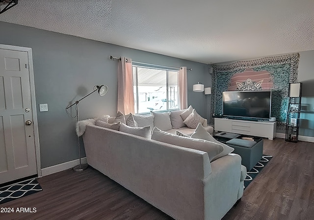 living room with dark hardwood / wood-style floors and a textured ceiling