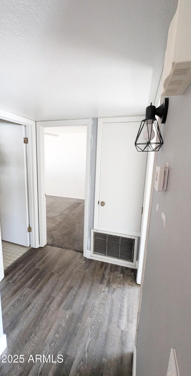 interior space with dark hardwood / wood-style flooring and a textured ceiling