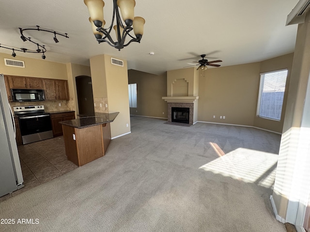 kitchen featuring electric range, visible vents, a peninsula, and black microwave