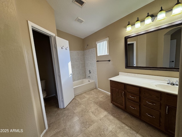 bathroom featuring vanity, toilet, baseboards, and visible vents