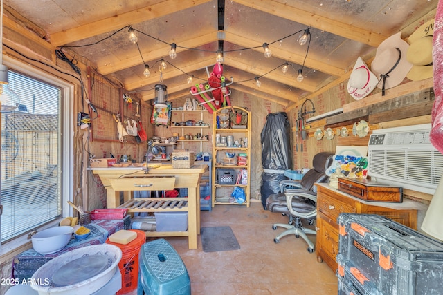 office with vaulted ceiling with beams, a workshop area, and wood walls