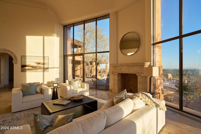 living room with light tile patterned flooring and a wall of windows