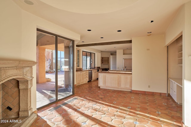 kitchen featuring dishwasher, sink, and light brown cabinetry