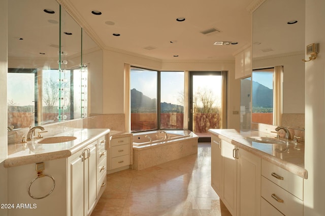 bathroom featuring tile patterned floors, a relaxing tiled tub, crown molding, and vanity