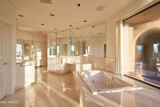 bathroom featuring tile patterned flooring, vanity, crown molding, and tiled tub