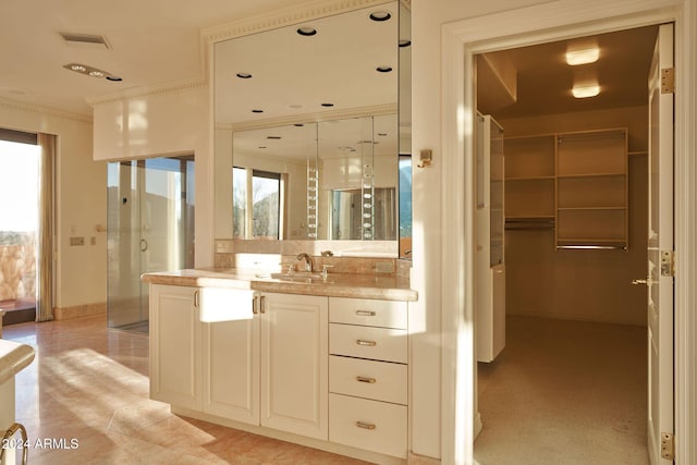 bathroom featuring vanity, plenty of natural light, and crown molding