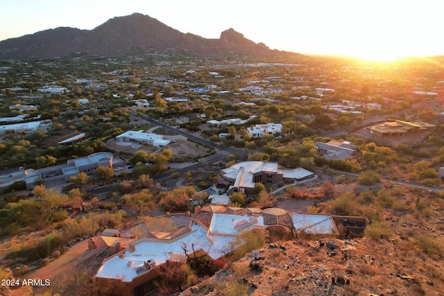 aerial view at dusk featuring a mountain view