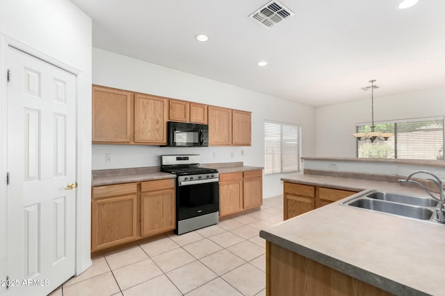 12726 W Charter Oak Rd, El Mirage, AZ 85335 - kitchen featuring a sink, black microwave, stainless steel gas stove, decorative light fixtures, and visible vents