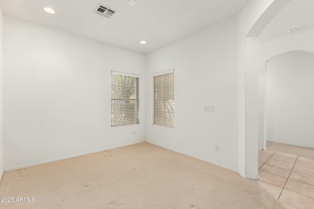 12726 W Charter Oak Rd, El Mirage, AZ 85335 - spare room with arched walkways, baseboards, visible vents, recessed lighting, and carpet floors