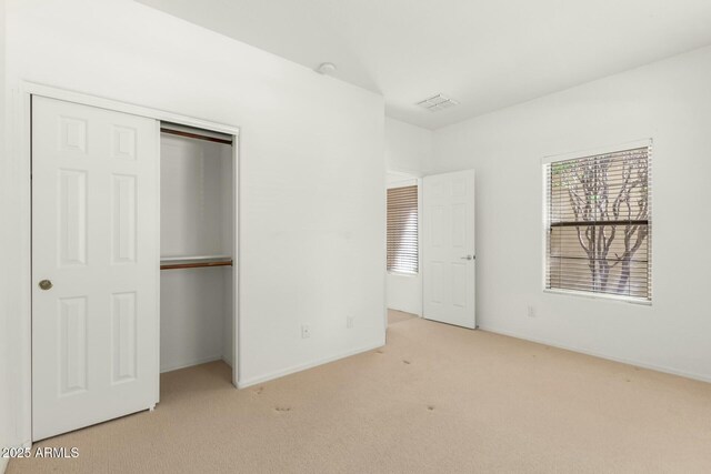 12726 W Charter Oak Rd, El Mirage, AZ 85335 - unfurnished bedroom with baseboards, visible vents, carpet, and a closet