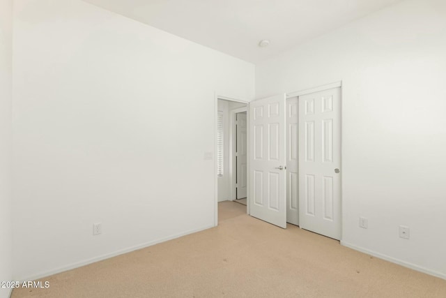 12726 W Charter Oak Rd, El Mirage, AZ 85335 - unfurnished bedroom with light carpet, baseboards, and a closet