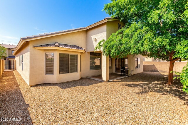 12726 W Charter Oak Rd, El Mirage, AZ 85335 - rear view of house with a patio, a fenced backyard, a tiled roof, and stucco siding