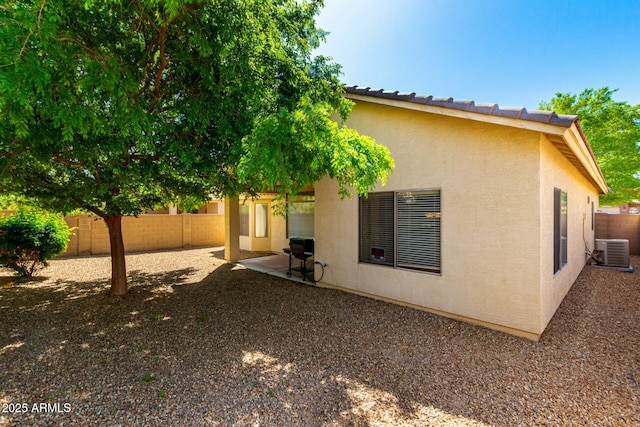12726 W Charter Oak Rd, El Mirage, AZ 85335 - rear view of house with a patio, central AC, a fenced backyard, and stucco siding