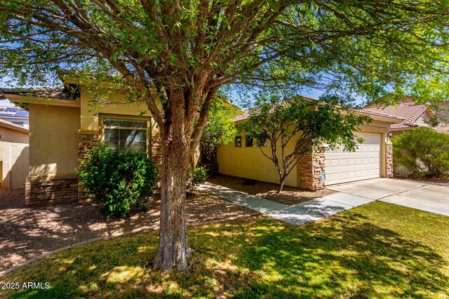 12726 W Charter Oak Rd, El Mirage, AZ 85335 - obstructed view of property with a tile roof, an attached garage, concrete driveway, and stucco siding