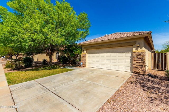 12726 W Charter Oak Rd, El Mirage, AZ 85335 - single story home featuring stone siding, a tiled roof, driveway, and stucco siding
