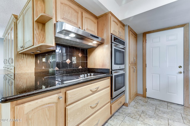 kitchen with dark stone counters, tasteful backsplash, black electric stovetop, light brown cabinets, and double oven