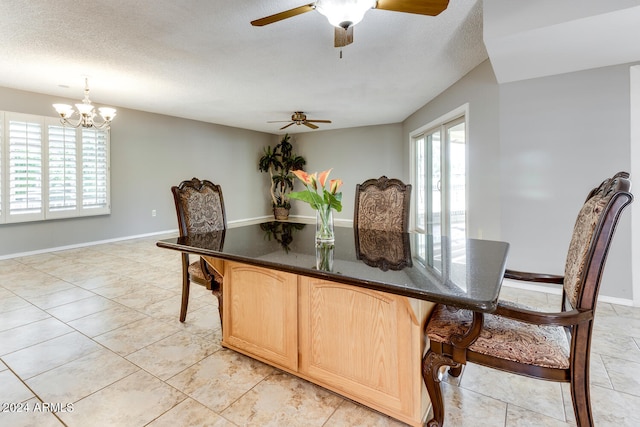 tiled dining area with ceiling fan with notable chandelier and a textured ceiling