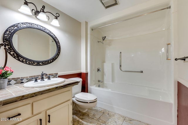 full bathroom with toilet, vanity, and shower / washtub combination