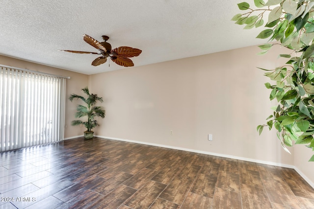 spare room with ceiling fan, dark hardwood / wood-style flooring, and a textured ceiling